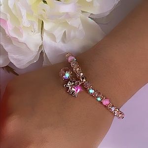 Pink beaded bracelet with different styles and charms